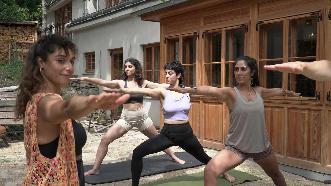A group practising yoga outdoors